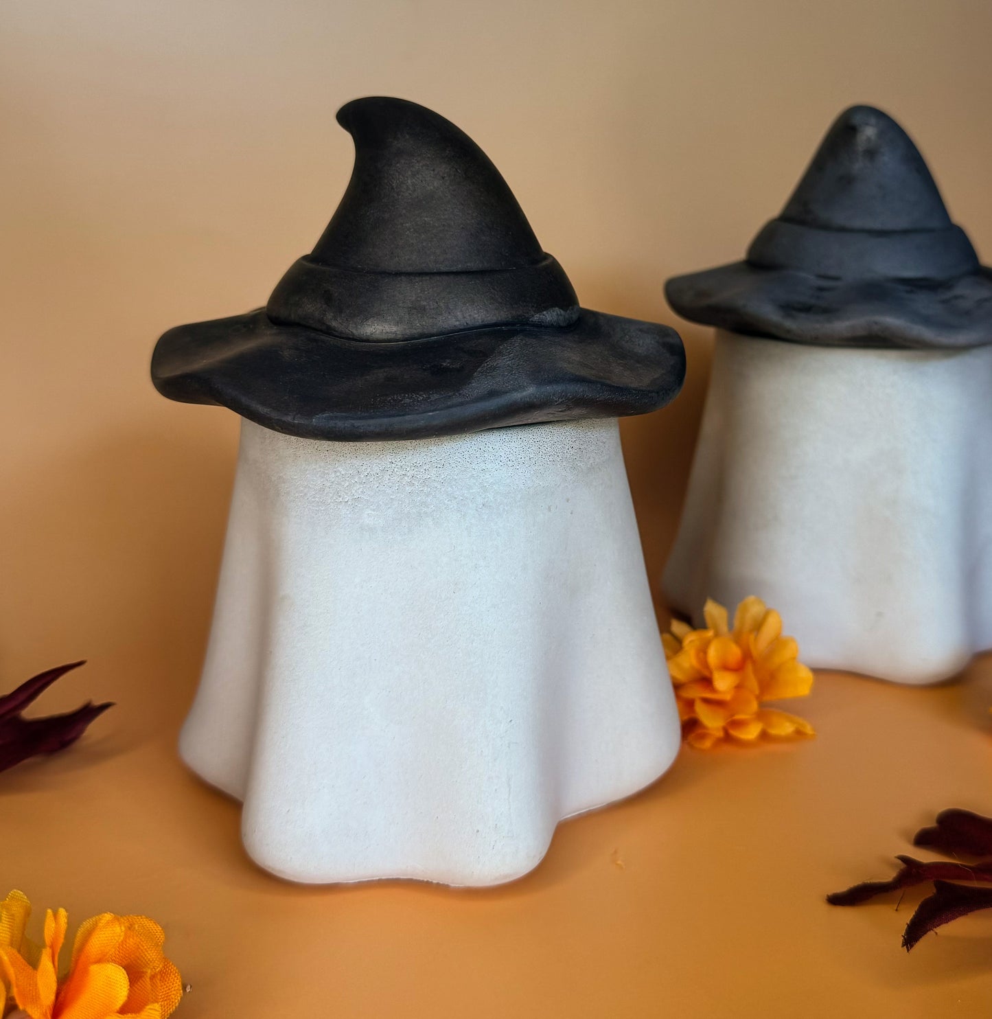 Wood wick luxury Halloween candle. Jar is shaped like a ghost with a witch or wizard hat as the lid. 