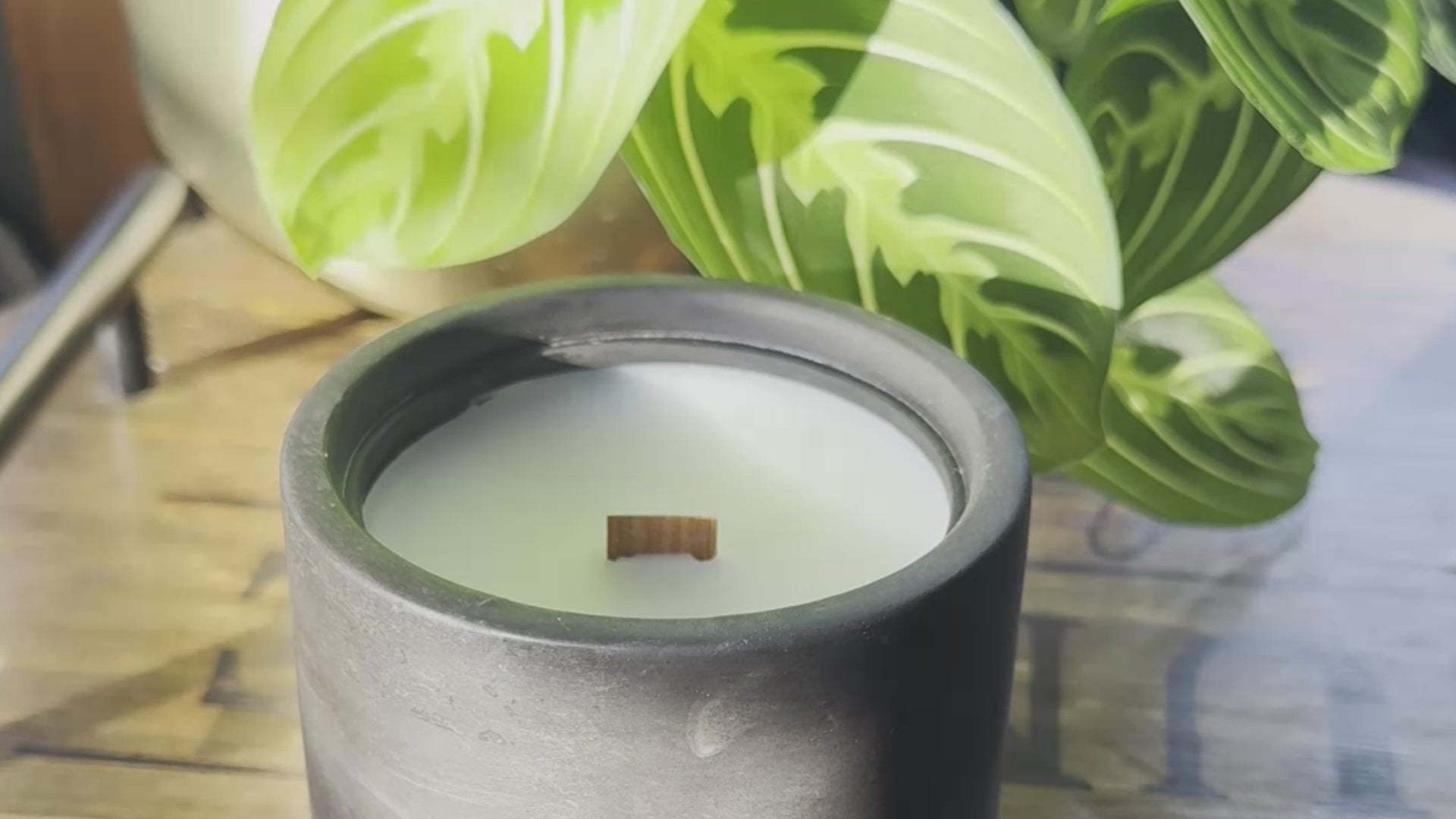 Load video: Lighting a wood wick candle with a match